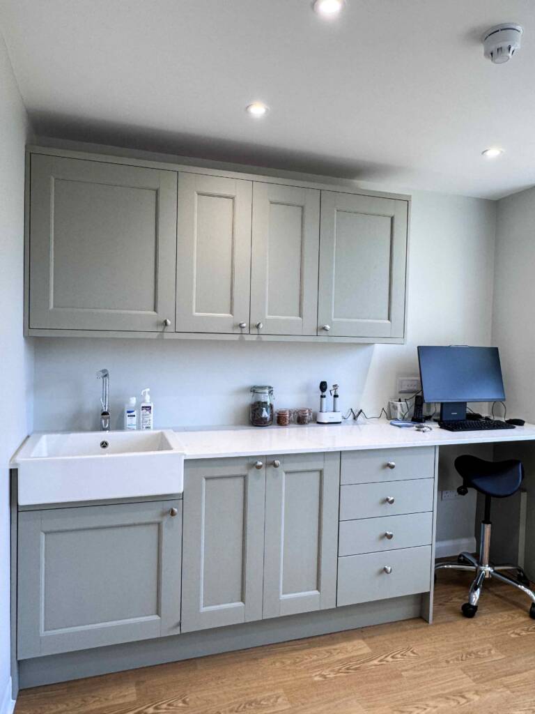 Haslemere Vets consultation room with cabinets and computer desk