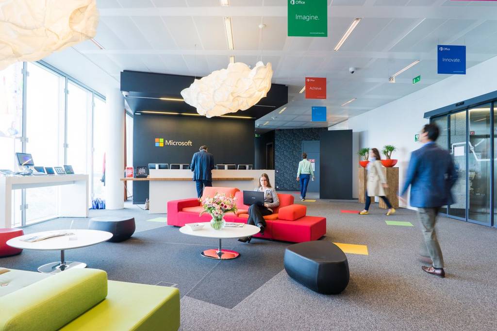 Modern, open plan office with sofas and standing desks